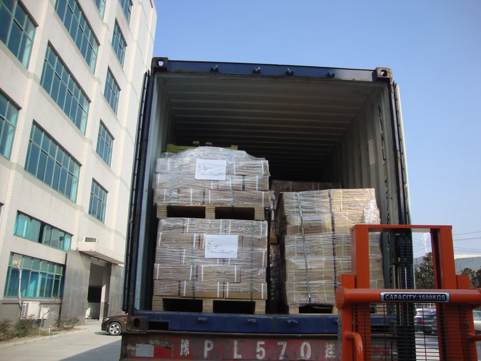 Shipping container being loaded with gas spring orders