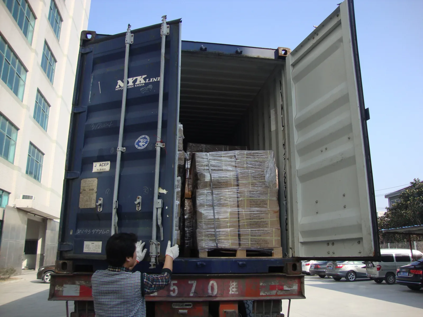 Container loaded with palletized gas spring cartons at the factory