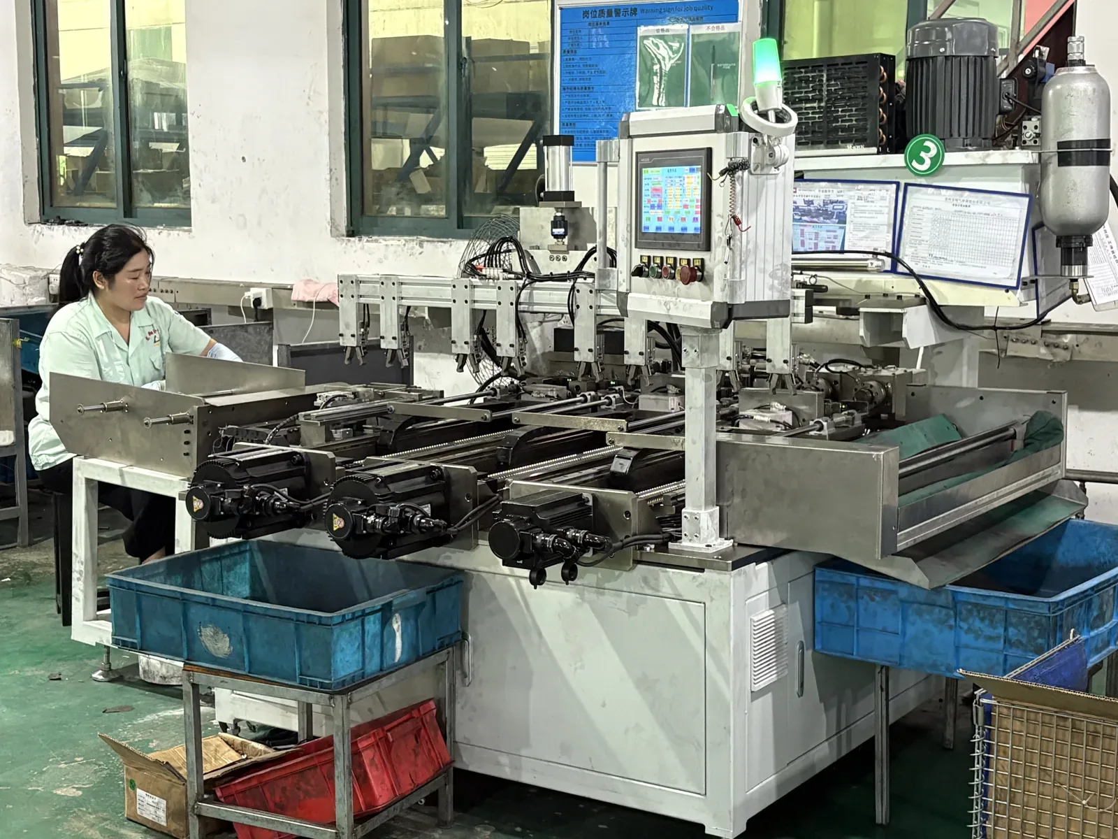Operator running a gas spring assembly station with process monitor